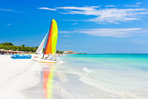 Scene with sailing boat at Varadero beach in Cuba