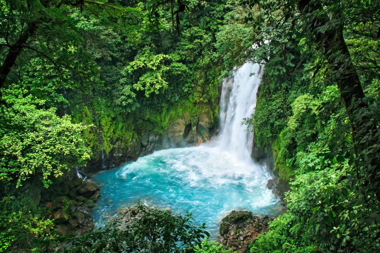 Rio Celeste Waterfall at Tenorio Volcano National Park in Guanacaste, Costa Rica. The colour of the water is an exceptionally bright sky blue.