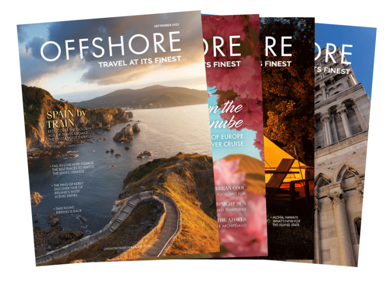 Offshore Travel Magazines lay in a fanned out stack with the Fall 2022 issue sitting on top