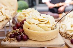 traditional-grana-padano-cheese-cutting-board-with-grapes-and-walnuts